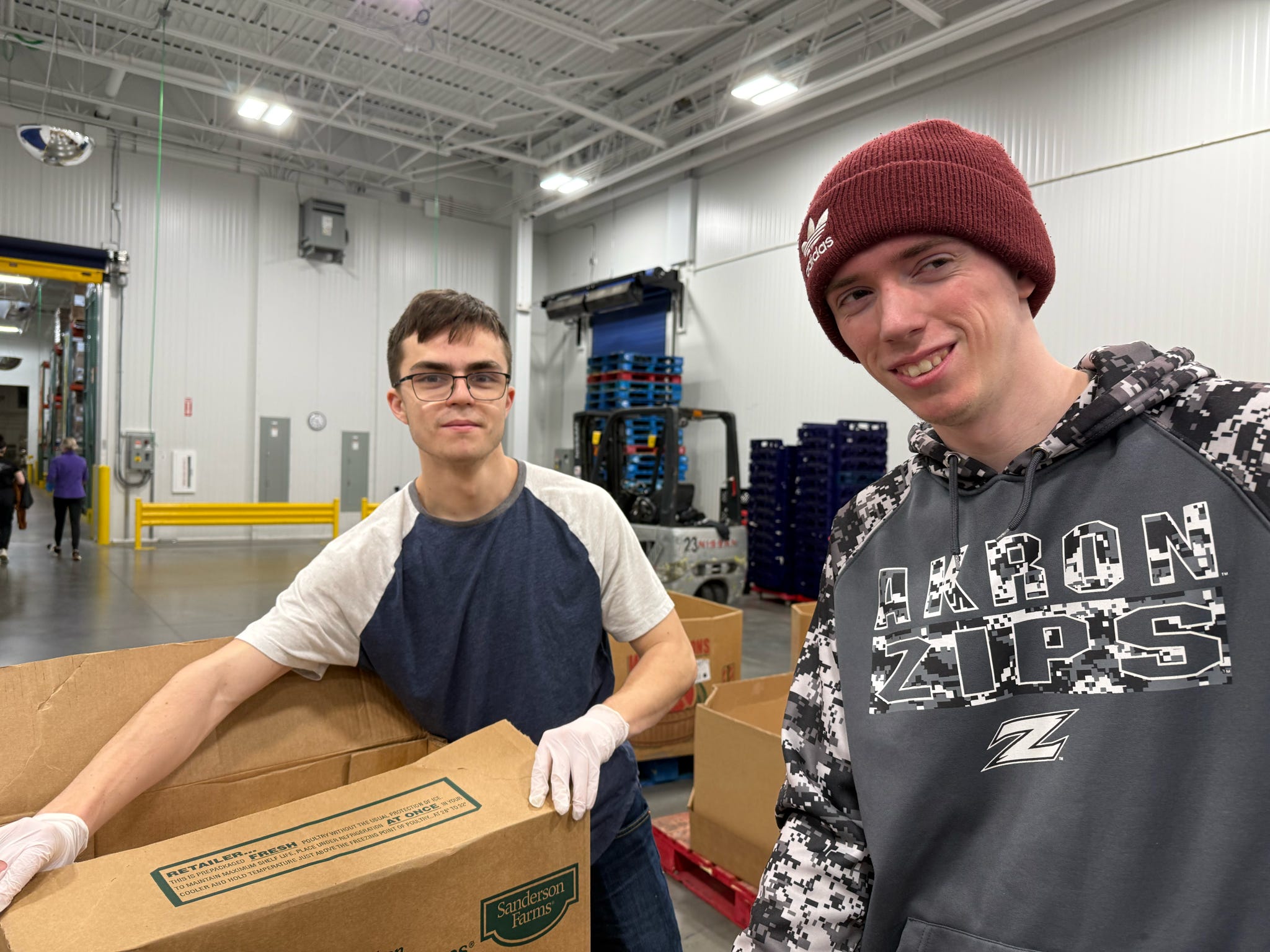 Brothers volunteering at a community food pantry